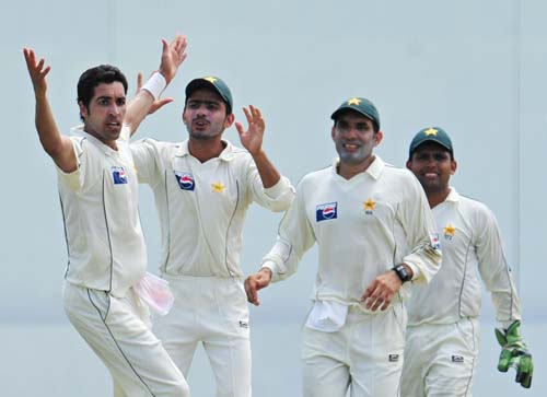 Umar Gul celebrates with teammate Fawad Alam, Misbah-ul-Haq and Kamran Akmal for the dismissal of Rangana Herath during the second day of the second Test match between Pakistan and Sri Lanka at The P. Saravanamuttu Stadium in Colombo. (AFP Photo) Day 2: Pak vs SL, 2nd Test
