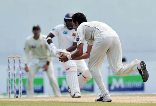 Rangana Herath watches as Umar Gul takes the catch to dismiss him during the second day of the second Test match between Pakistan and Sri Lanka at The P. Saravanamuttu Stadium in Colombo. (AFP Photo) Day 2: Pak vs SL, 2nd Test