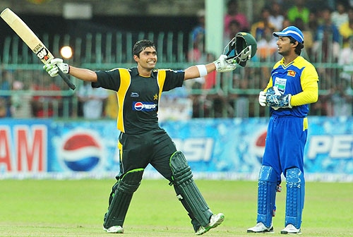 Umar Akmal raises his bat and helmet as he celebrates his maiden century during the fourth One-Day International between Sri Lanka and Pakistan at The R Premadasa Stadium in Colombo. (AFP Photo) Pak vs SL: 4th ODI