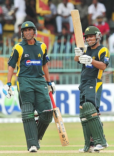 Kamran Akmal is watched by Younus Khan as he celebrates scoring a half-century during the fourth One-Day International between Sri Lanka and Pakistan at The R Premadasa Stadium in Colombo. (AFP Photo) Pak vs SL: 4th ODI