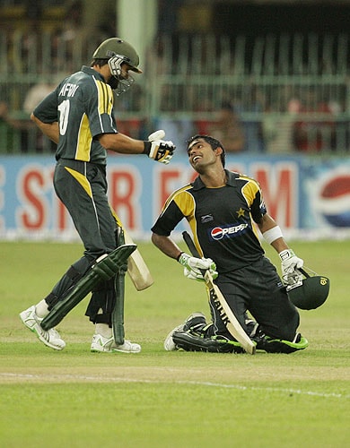 Umar Akmal celebrates after completing a century as teammate Shahid Afridi congratulates him during the fourth One-Day International between Sri Lanka and Pakistan. (AP Photo) Pak vs SL: 4th ODI