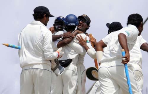 Sri Lankan cricketers celebrate their team's victory with Kumar Sangakkara at the conclusion of the fourth day of the first Test match between Pakistan and Sri Lanka at The Galle International Stadium in Galle. (AFP Photo) Day 4: Pak vs SL, 1st Test