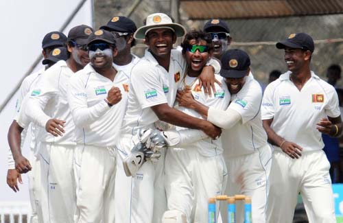 Sri Lankan cricketers celebrate the dismissal of Misbah-ul-Haq during the fourth day of the first Test match between Pakistan and Sri Lanka at The Galle International Stadium in Galle. (AFP Photo) Day 4: Pak vs SL, 1st Test