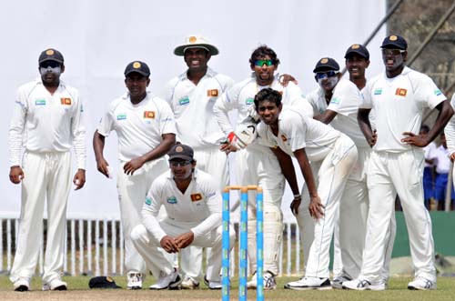 Sri Lankan cricketers look on as they wait for a decision from the third umpire for the wicket of Misbah-ul-Haq during the fourth day of the first Test match between Pakistan and Sri Lanka at The Galle International Stadium in Galle. (AFP Photo) Day 4: Pak vs SL, 1st Test