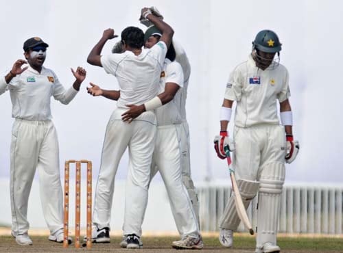 Thilan Thushara celebrates with teammates after the dismissal Shoaib Malik during the fourth day of the first Test match between Pakistan and Sri Lanka at The Galle International Stadium in Galle. (AFP Photo) Day 4: Pak vs SL, 1st Test