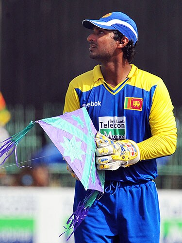 Kumar Sangakkara picks up a kite after it landed on the grounds during the fifth and final One-Day International match between Sri Lanka and Pakistan at The R Premadasa Stadium in Colombo. (AFP Photo) Pak vs SL: 5th ODI