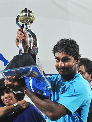 Kumar Sangakkara gestures as he holds the trophy follwong the fifth and final One-Day International match between Sri Lanka and Pakistan at The R Premadasa Stadium in Colombo. (AFP Photo) Pak vs SL: 5th ODI
