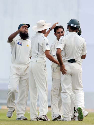 Mohammad Aamer is congratulated by his teammates after dismissing Thilan Thushara during the first Test match between and Sri Lanka at The Galle International Stadium. (AFP Photo) Day 1: Pak vs SL, 1st Test