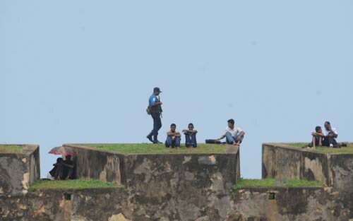 A Sri Lankan security official stands guard on the 16th Century Dutch fort overlooking The Galle International Stadium. (AFP Photo) Day 1: Pak vs SL, 1st Test