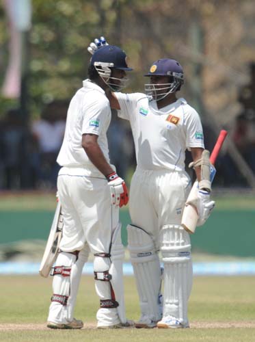 Tharanga Paranavitana is congratulated by his teammate Mahela Jayawardene after scoring a half-century during the first Test match between and Sri Lanka at The Galle International. (AFP Photo) Day 1: Pak vs SL, 1st Test
