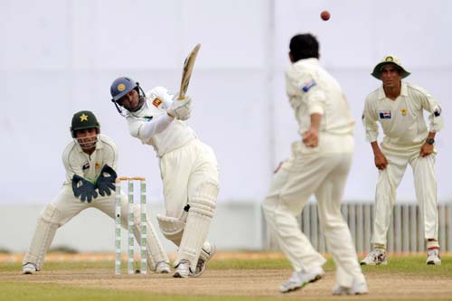 Tillakaratne Dilshan hits a stroke while watched by wicketkeeper Kamran Akmal and captain Younus Khan during the first Test match between and Sri Lanka at The Galle International Stadium. (AFP Photo) Day 1: Pak vs SL, 1st Test