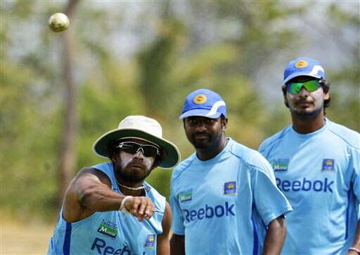 Kumar Sangakkara and Muttiah Muralitharan look on as Lasith Malinga throws the ball during a practice session at The Rangiri Dambulla International stadium in Dambulla. (AP Photo) Lanka in nets at Dambulla