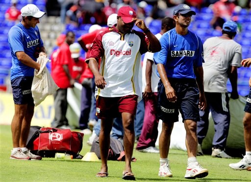 West Indies captain Brian Lara, left, walks with India captain Rahul Dravid after inspecting the pitch prior to the start of the first day of the third cricket test match at St. Kitts. Ind-WI 3rd Test Day 1