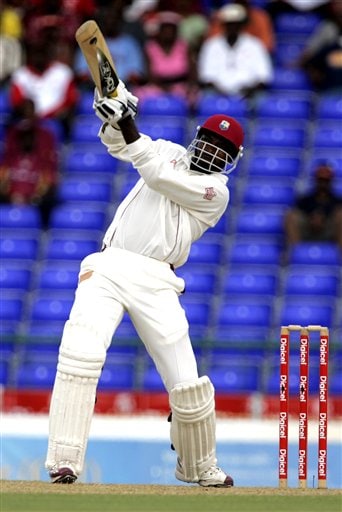 West Indies batsman Chris Gayle hits a six off the bowling of India's SSreesanth, not seen, on the first day of the third cricket test match at St. Kitts. Ind-WI 3rd Test Day 1