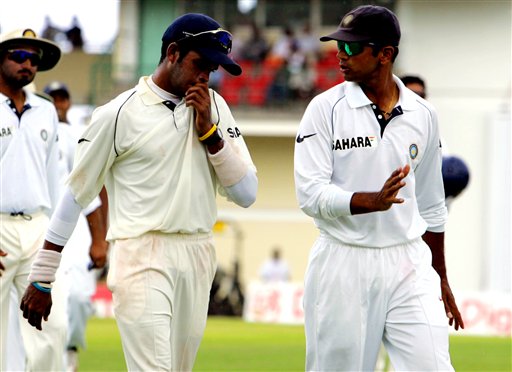India bowler S Sreesanth, left, talks with captain Rahul Dravid, as they walk off the field when rain stopped play on the first day of the third cricket test match at St. Kitts. Ind-WI 3rd Test Day 1