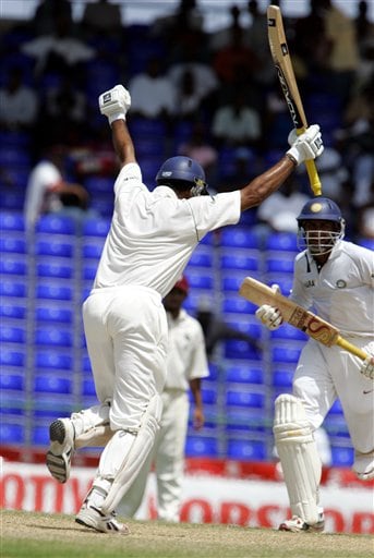 India's batsman VVS Laxman, left, celebrates after scoring a century against the West Indies on the fourth day of the third cricket Test match at Warner Park in Basseterre, St Kitts, Sunday, June 25, 2006. At right is Anil Kumble. (AP Photo/Lynne Sladky) Ind-WI 3rd Test Day 4