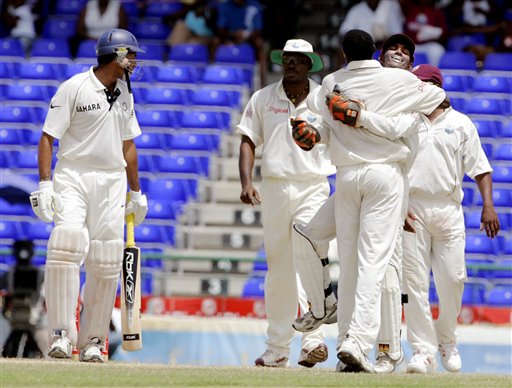 Indian batsman VVS Laxman, left, watches as West Indies wicketkeeper Denesh Ramdin, right, hugs bowler Pedro Collins, back to camera, after Laxman was caught off the bowling of Collins for 311 for 8 on the fourth day of the third cricket Test match at Warner Park in Basseterre, St Kitts, Sunday, June 25, 2006. (AP Photo/Lynne Sladky) Ind-WI 3rd Test Day 4