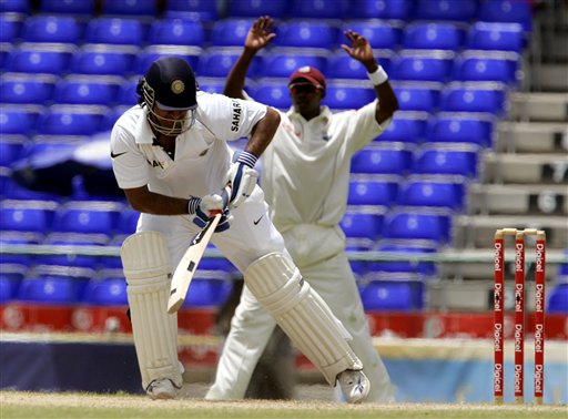 India's batsman Mahendra Dhoni, left, is out LBW off the bowling of West Indies' Corey Collymore, not shown, for 220 for 6 on the fourth day of the third cricket Test match at Warner Park in Basseterre, St Kitts, Sunday, June 25, 2006. At right is Dwayne Bravo of the West Indies. (AP Photo/Lynne Sladky) Ind-WI 3rd Test Day 4