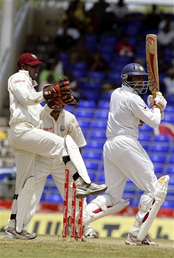 India's batsman Anil Kumble, right, bats as West Indies wicketkeeper Denesh Ramdin, left, kicks up his leg on the fourth day of the third cricket Test match at Warner Park in Basseterre, St Kitts, Sunday, June 25, 2006. Kumble scored 43 runs before being caught off the bowling of Pedro Collins. (AP Photo/Lynne Sladky) Ind-WI 3rd Test Day 4