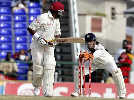 West Indies captain Brian Lara, left, looks as he is stumped by India's wicketkeeper Mahendra Dhoni, right, for 81 for 3 in the second innings on the fourth day of the third cricket Test match at Warner Park in Basseterre, St Kitts, Sunday, June 25, 2006. (AP Photo/Lynne Sladky) Ind-WI 3rd Test Day 4