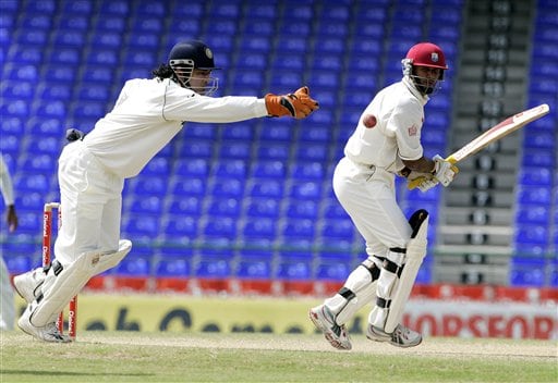 West Indies batsman Daren Ganga, right, bats as India's wicket keeper Mahendra Dhoni reaches for the ball on the fifth day of the third cricket test match at St Kitts. Ind-WI 3rd Test Day 5
