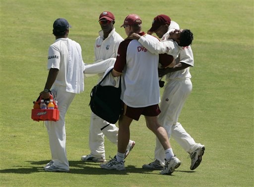 West Indies' Ramnaresh Sarwan is carried off the field after being injured while trying to make a catch during the fourth and final Test match against India at Kingston. Ind-WI 4th Test Day 1