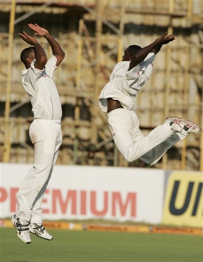 West Indies bowler Jerome Taylor, right, leaps into the air as he celebrates with Corey Collymore, left, after getting the wicket of India's Munaf Patel during the fourth cricket Test match at Kingston. Ind-WI 4th Test Day 1