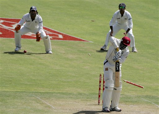 West Indies batsman Chris Gayle, right, is bowled for a duck by India's bowler S Sreesanth, not seen, for 0 on the second day of the fourth cricket Test at Kingston. Ind-WI 4th Test Day 2