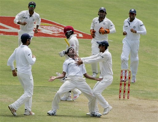 India's bowler S Sreesanth, front center, celebrates after West Indies batsman Brian Lara, center carrying bat, was caught by Wasim Jafffer on the second day of the fourth cricket Test at Kingston. Ind-WI 4th Test Day 2