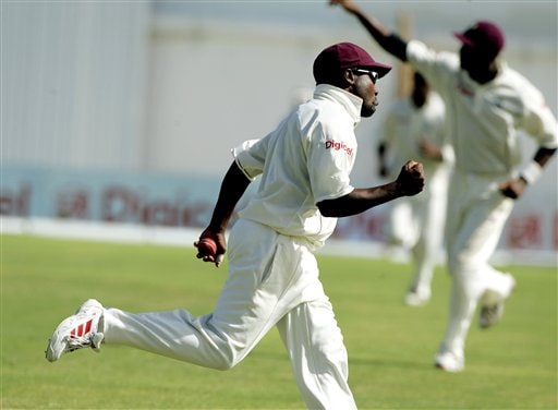 West Indies captain Brian Lara runs with the ball while celebrating catching India's batsman VVS Laxman off the bowling of Corey Collymore on the second day of the fourth cricket Test at Kingston. Ind-WI 4th Test Day 2