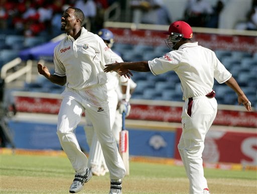 West Indies bowler Corey Colleymore, left, celebrates with Darren Ganga, right, after taking the wicket of India's batsman Yuvraj Singh on the second day of the fourth cricket Test at Kingston. Ind-WI 4th Test Day 2