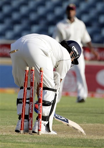 India's batsman M S Dhoni is bowled by West indies bowler Jerome Taylor on the second day of the fourth cricket Test at Kingston. Ind-WI 4th Test Day 2