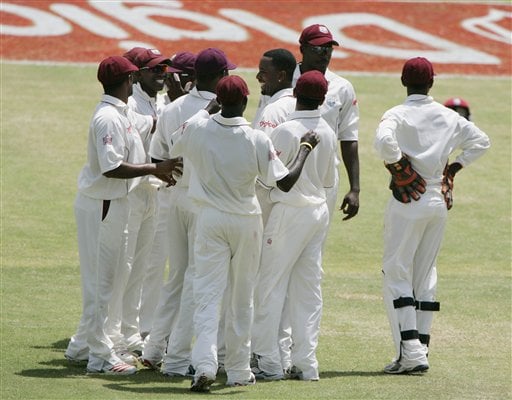 West Indies bowler Corey Collymore, center facing left, is congratulated by his teammates after he bowled India's captain Rahul Dravid for 154 for 8 on the third day of the fourth and final cricket test match at Sabina Park in Kingston, Jamaica Sunday, July 2, 2006. Ind-WI 4th Test Day 3