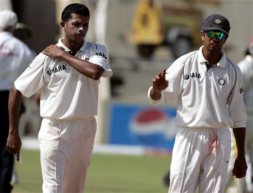 India's bowler Shanthakumaran Sreesanth, left, talks with captain Rahul Dravid, right,on the third day of the fourth and final cricket test match at Sabina Park in Kingston, Jamaica Sunday, July 2, 2006. India went on to win by 49 runs, and won the series 1-0. Ind-WI 4th Test Day 3