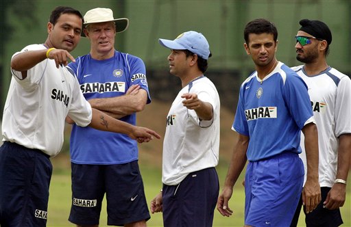 Dinesh Mongia, left, speaks to teammate Sachin Tendulkar, centre, as team coach Greg Chappell, second left, Captain Rahul Dravid, second right, and cricketer Harbhajan Singh look on, as the Indian team prepares for the tri-nation series in Malaysia. India gears up for DLF Cup