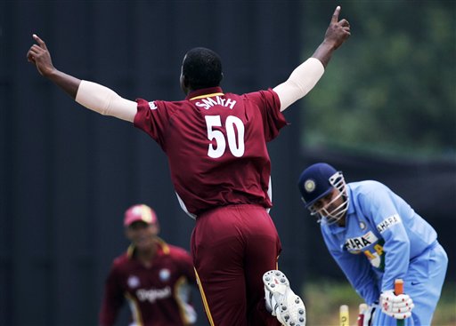 West Indies' bowler Dwayne Smith, left, celebrates after bowling Indian batsman Virender Sehwag for 1 run in their tri-series match in Kuala Lumpur on Wednesday. DLF Cup Rd 2 Ind-WI
