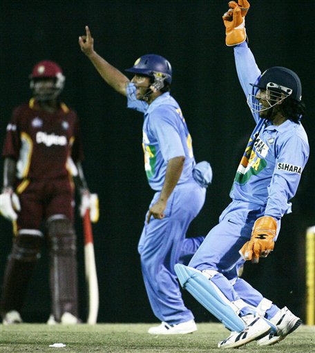 India's Mahendra Singh Dhoni, right, and Suresh Raina share celebration styles after the stumping of India's Dwayne Bravo in their tri-series cricket match in Kuala Lumpur on Wednesday. DLF Cup Rd 2 Ind-WI