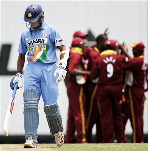 Indian captain Rahul Dravid, left, walks off after he was caught behind for no score as the West Indies celebrate in their tri-series match in Kuala Lumpur on Wednesday. DLF Cup Rd 2 Ind-WI