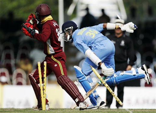 Indian batsman S Sreesanth, right, races into his crease but not before he is run out by the West Indies' wicketkeeper Carlton Baugh for no score in their tri-series match in Kuala Lumpur on Wednesday. DLF Cup Rd 2 Ind-WI