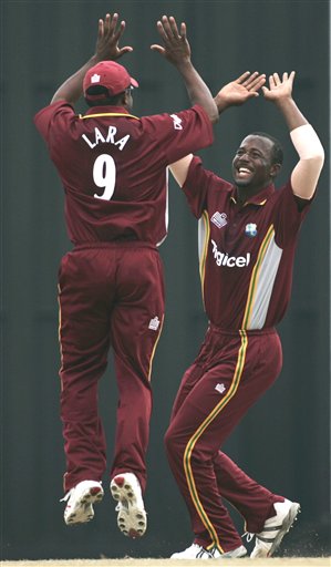 West Indies' captain Brian Lara, left, jumps up to celebrate with bowler Dwayne Smith after the dismissal of Indian batsman Yuvraj Singh for no score in their tri-series match in Kuala Lumpur on Wednesday. DLF Cup Rd 2 Ind-WI