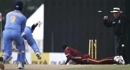 Indian batsman Sachin Tendulkar, second left, is run out for 65 runs after his batting partner Rudra Pratap Singh, left, had a drive deflected onto the stumps by West Inides' bowler Marlon Samuels, right, in their tri-series match in Kuala Lumpur on Wednesday. DLF Cup Rd 2 Ind-WI