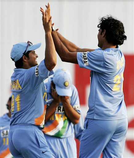 India's Manuf Patel, right, and Suresh Raina celebrate the wicket of West Indies' batsman Ramnaresh Sarwan for 2 runs as their captain Rahul Dravid, center, holds his head after he was hit with the ball during the celebrations in their tri-series match in Kuala Lumpur on Wednesday. DLF Cup Rd 2 Ind-WI