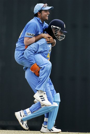 Indian teammates Suresh Raina, left, and Mahendra Singh Dhoni celebrate the wicket of Australia's Matthew Hayden for 54 runs in their tri-series cricket match in Kuala Lumpur on Friday. DLF Cup Rd 2 Ind-Aus