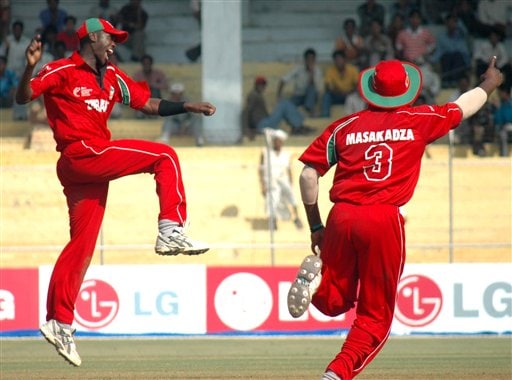 Zimbabwe's cricketers Elton Chigumbura, left, and Hamilton Masakadza celebrate a dismissal during the ICC Champions Trophy qualifying match in Ahmedabad on Tuesday. ICC CT Sri Lanka-Zimbabwe