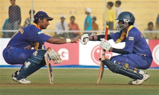 Sri Lankan cricketer Upul Tharanga, right, and Kumar Sangakkara, gesture during a break at the ICC Champions Trophy qualifying match in Ahmedabad on Tuesday. ICC CT Sri Lanka-Zimbabwe