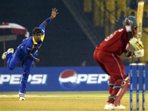 Sri Lanka's Lasith Malinga, left, bowls to Tafadzwa Mufambishi of Zimbabwe, during ICC Champions Trophy's qualifying match at Ahmedabad on Tuesday. ICC CT Sri Lanka-Zimbabwe