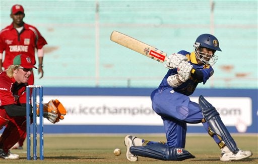 Sri Lankan cricketer Upul Tharanga, right, bats as Zimbabwe wicket keeper Brendon Taylor, left, gestures during the ICC Champions Trophy qualifying match at Ahmedabad on Tuesday. ICC CT Sri Lanka-Zimbabwe