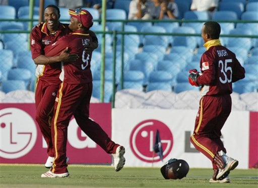 West Indies cricket captain Brian Lara, second left, congratulates Dwayne Bravo, left, as wicket keeper Carlton Baugh, joins in after the dismissal of Bangladesh's Masharafe Bin Mortaza, unseen, during the ICC Champions Trophy qualifying match in Jaipur on Wednesday. ICC CT WI-Bangladesh