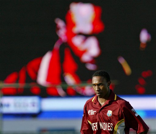 West Indies cricketer Dwayne Bravo looks on as he is shown on a giant screen in the background, during the match against Bangladesh at the ICC Champions Trophy qualifying match in Jaipur on Wednesday. ICC CT WI-Bangladesh