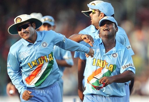 India's Ramesh Powar, right and Virender Sehwag celebrate the dismissal of England's James Anderson, unseen, during the one day international cricket match for the ICC Champions Trophy in Jaipur on Sunday. ICC CT India-England